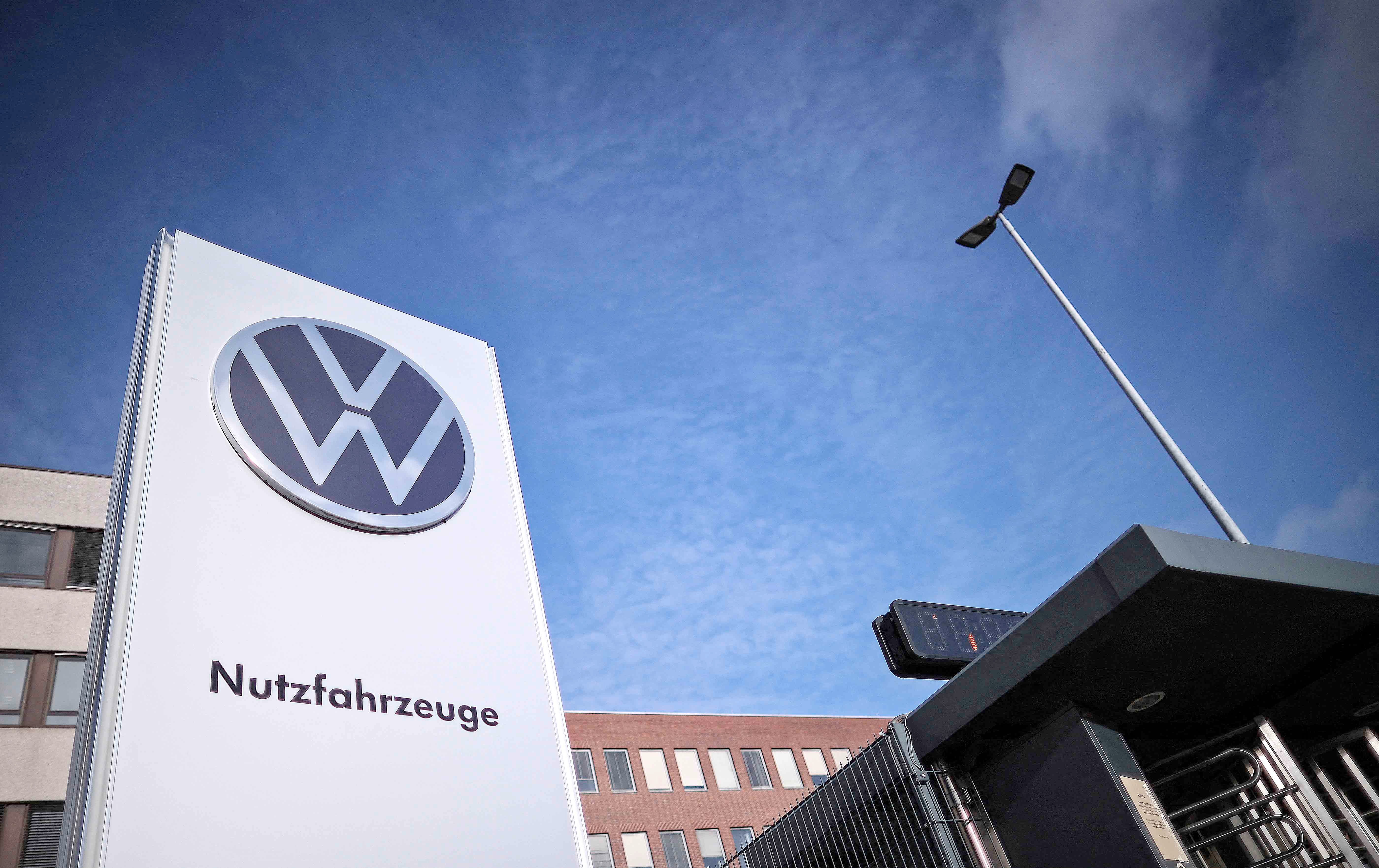 A general view of the entrance of the commercial vehicle plant of German car manufacturer Volkswagen with its logo on a board reading ‘Commercial vehicles’ (Nutzfahrzeuge) is pictured on 20 December 2024 in Hanover, northern Germany. The crisis-wracked auto titan has been locked in bitter talks with unions since announcing in September that it was mulling the unprecedented step of shuttering plants in Germany.