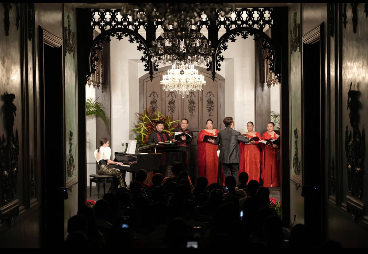 The University of Santo Tomas Singers with founder and conductor Fidel Calalang Jr. and Anya Lagman at the piano.