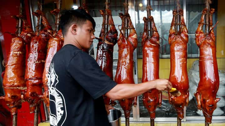 Workers prepare delicious lechon baboy (roasted pig) at various stores in La Loma, Quezon City, on Sunday, 22 December, 2024. Lechon remains a popular choice for Noche Buena, the traditional Christmas Eve feast.