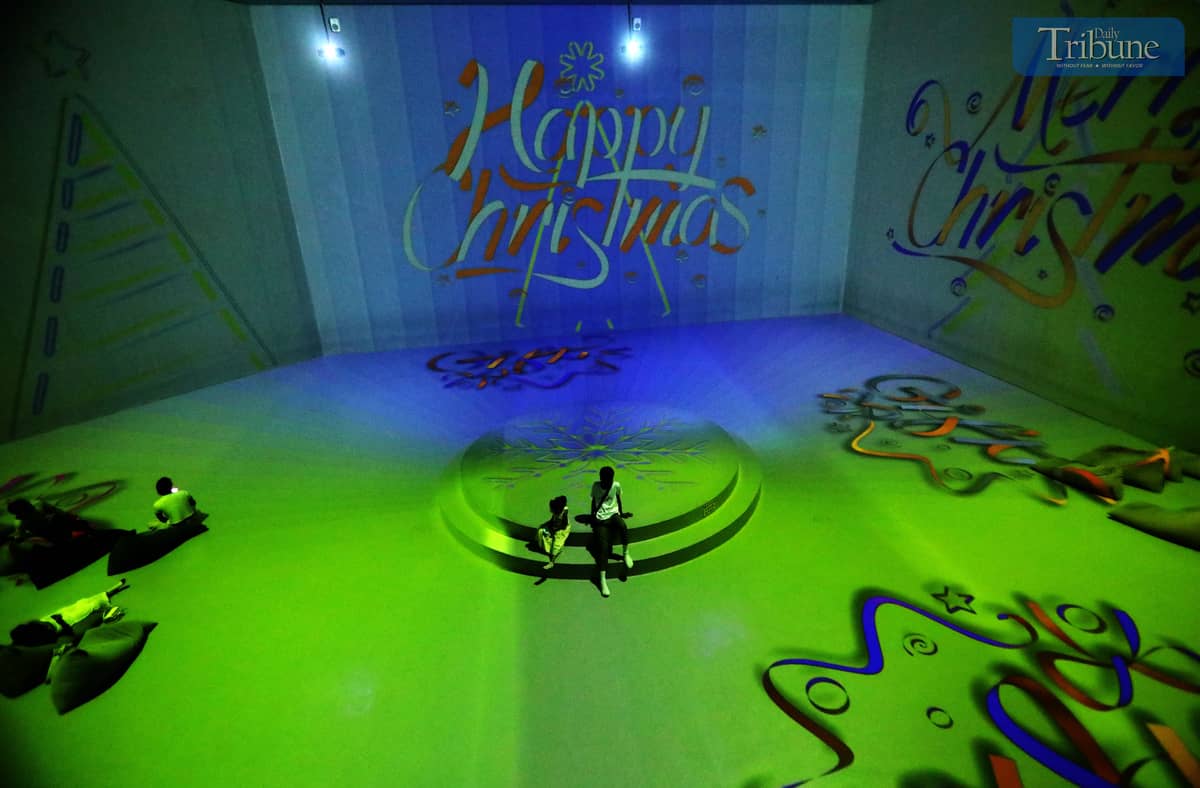 People enjoy their holiday break by exploring 3D art installations and festive Christmas displays at Art in Island, Quezon City, on Monday, 23 December 2024, just a day before Christmas Eve.