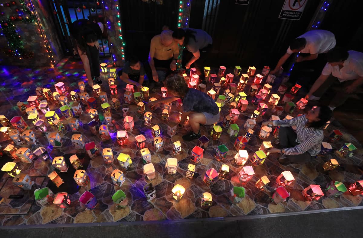 People light candles during the Day of the Little Candles ('Dia de las velitas') in Envigado, Antioquia department, Colombia, on 7 December 2024. The Day of the Little Candles is a traditional Colombian celebration of the Immaculate Conception of the Virgin Mary, marking the beginning of the Christmas season.