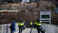 South Korea's impeached president resists arrest over martial law bid