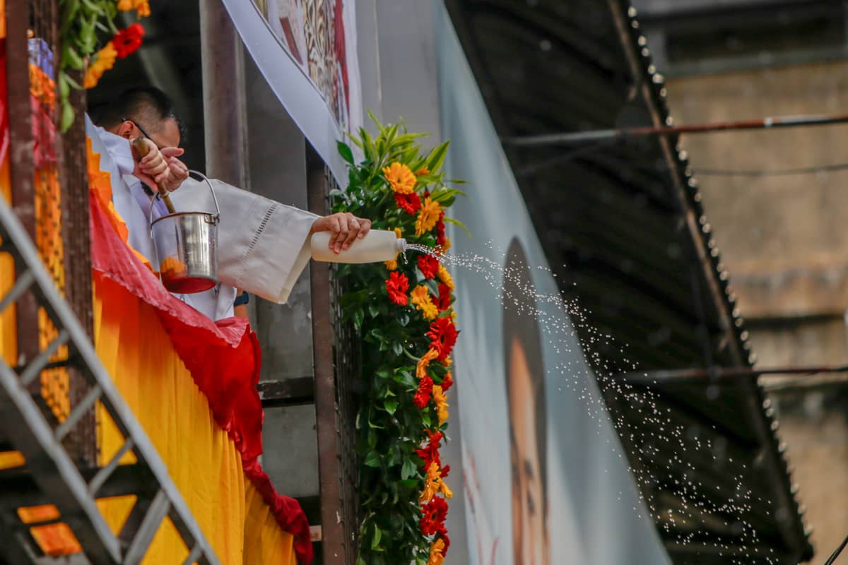 A priest squeezed a bottle of holy water over the footbridge in Quiapo, Manila, to bless Nazareno replicas on Thursday, 2 January.