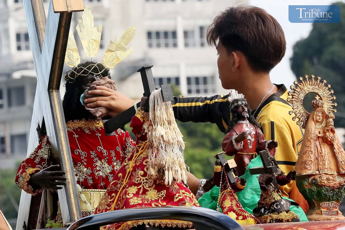 On Thursday, 2 January, a devotee wipes a replica of the Black Nazarene aboard a vehicle en route to Quiapo Church for a blessing ahead of the 9 January feast.