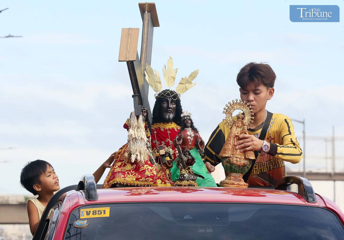 On Thursday, 2 January, a devotee wipes a replica of the Black Nazarene aboard a vehicle en route to Quiapo Church for a blessing ahead of the 9 January feast.