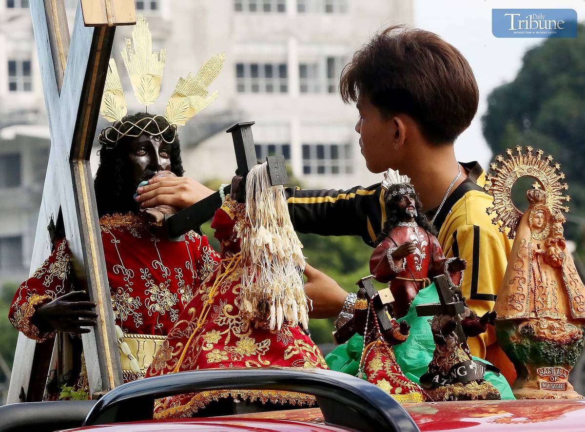 On Thursday, 2 January, a devotee wipes a replica of the Black Nazarene aboard a vehicle en route to Quiapo Church for a blessing ahead of the 9 January feast.