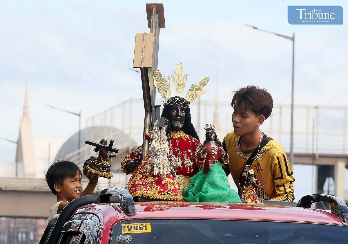 On Thursday, 2 January, a devotee wipes a replica of the Black Nazarene aboard a vehicle en route to Quiapo Church for a blessing ahead of the 9 January feast.