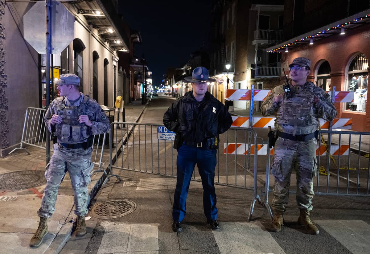 Members of the National Guard and police look on at a blocked off street, a block from Bourbon Street, after at least 15 people were killed during an attack early in the morning on 1 January 2025 in New Orleans, Louisiana. A US army veteran with an Islamic State flag and "hellbent" on carnage steered a pickup truck into a crowd of New Year revelers in New Orleans on 1 January, killing at least 15 people and wounding dozens, officials said. The FBI identified the attacker as Shamsud-Din Jabbar, a 42-year-old US citizen from Texas.