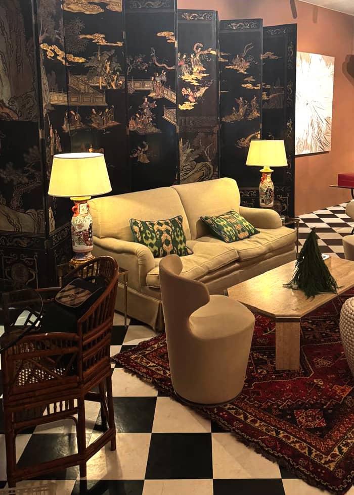 A seating area anchored by a Ching Dynasty coromandel screen.