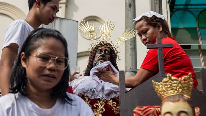 Devotees begin early with the ritual of wiping a handkerchief on a replica of the Jesus Nazareno outside the Minor Basilica of Quiapo. This act of veneration marks their preparation for the upcoming religious festivity on 9 January, which is expected to draw millions of believers to honor the revered icon.