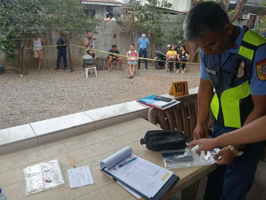 Authorities gather evidence outside a home in San Nicolas, Ilocos Norte, where a father fatally shot his 25-year-old son following a domestic argument on 3 January 2025.