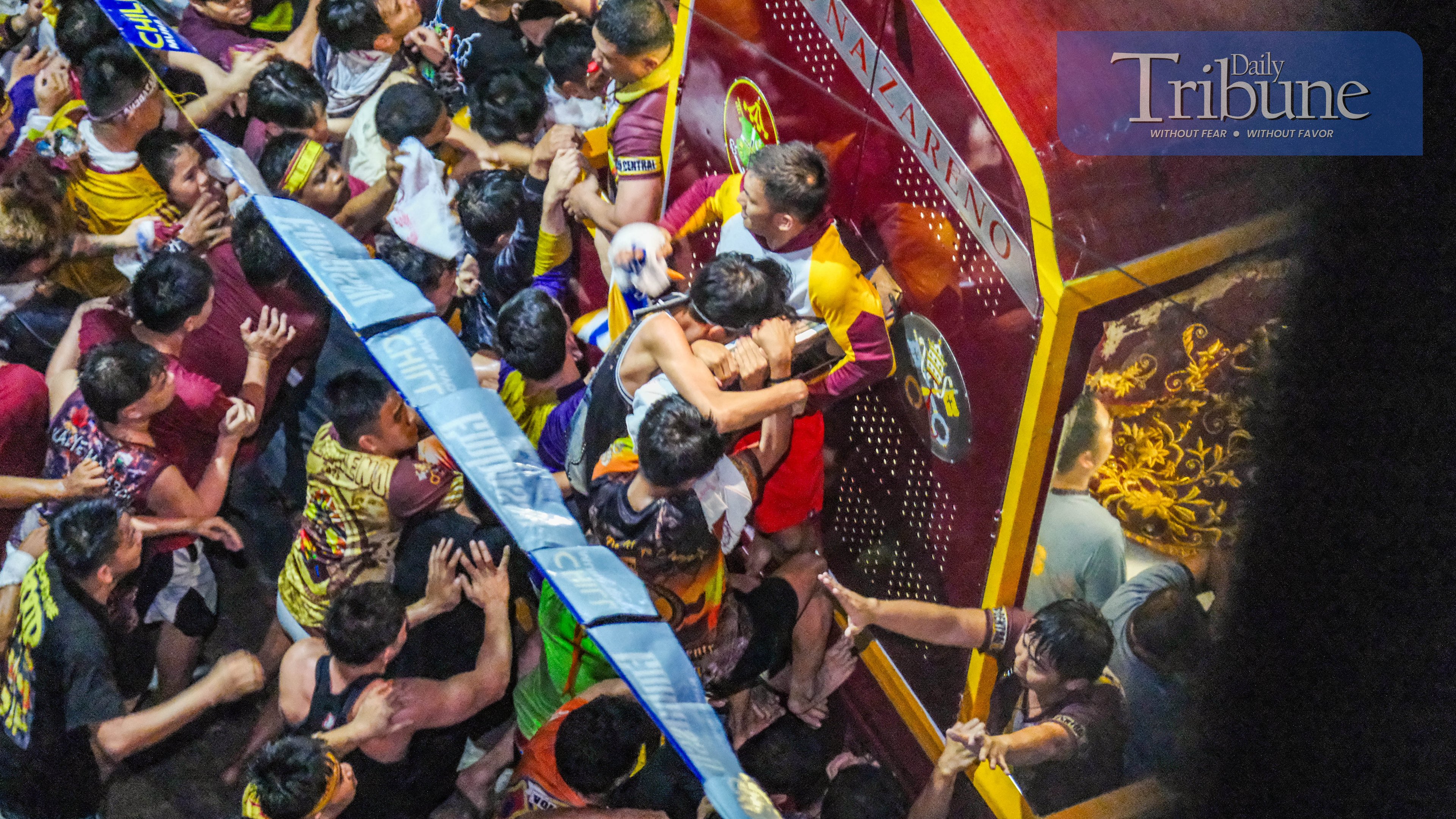 Devotees fearlessly attempt to touch the image of the Black Nazarene, driven by their faith in its powers and their panata (devotional vow).  
PHOTO BY YUMMIE DINGDING