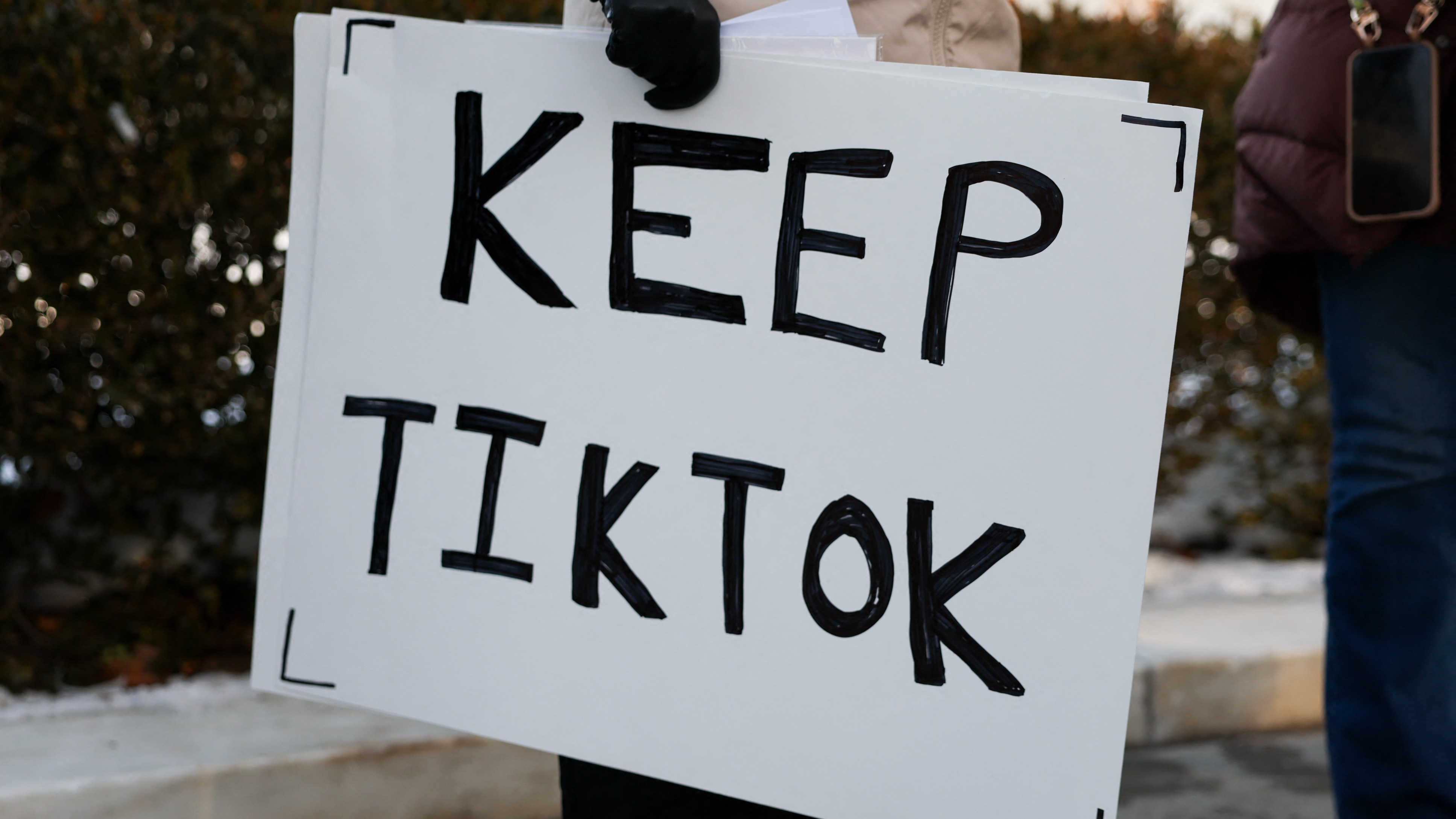 WASHINGTON, DC - 10 JANUARY: A TikTok influencer holds a sign that reads "Keep TikTok" outside the U.S. Supreme Court Building as the court hears oral arguments on whether to overturn or delay a law that could lead to a ban of TikTok in the U.S., on 10 January 2025 in Washington, DC. The future of the popular social media platform is at stake as the Supreme Court hears arguments on a law set to take effect the day before Inauguration Day that would force their China-based parent company to cut ties with TikTok due to national security concerns.