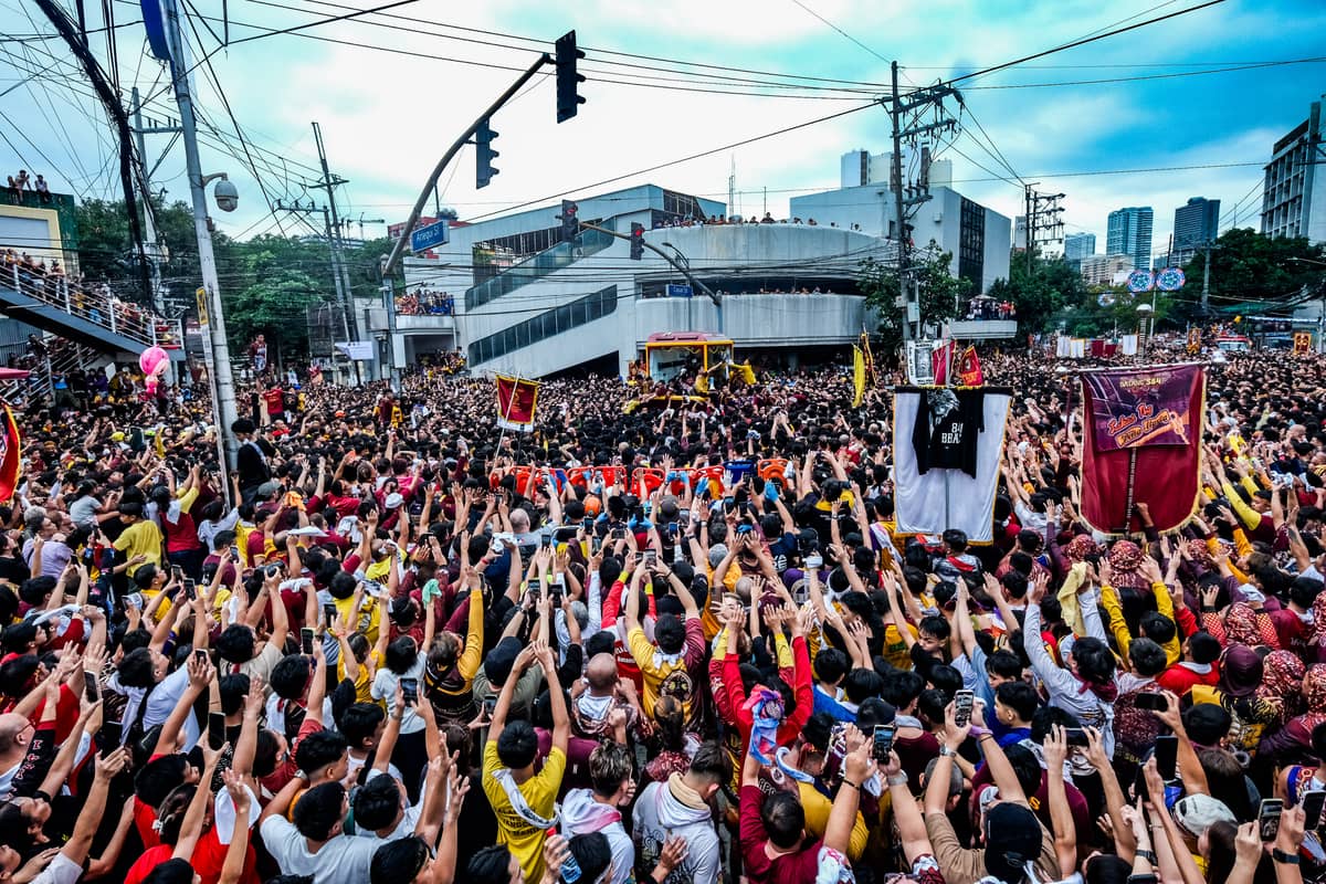 Thousands hold their hands up as the andas passes by. TheTraslacion procession goes around Quiapo and vicinity, and this 2025, it lasted for more than 20 hours.