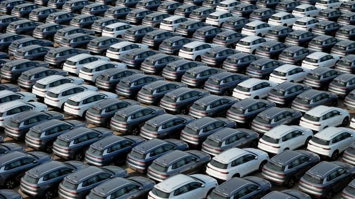 This photo taken on 18 April 2024 shows BYD electric cars for export waiting to be loaded onto a ship at a port in Yantai, in eastern China's Shandong province. Sales of electric and hybrid vehicles jumped more than 40 percent in China in 2024, as demand for new energy models continues to surge and the sector remains entrenched in a gruelling price war.