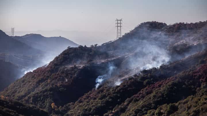 Wildfire smoke and hotspots from the Palisades fire area seen from Encino Hill on 12 January 2025 in Encino neighborhood of Los Angeles, California. Multiple wildfires fueled by intense Santa Ana Winds are still burning across Los Angeles County while some containment has been achieved. At least 16 people have died and over 100,000 people are still under evacuation orders. Over 12,000 structures have been destroyed in the fires.