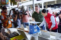 Trade Secretary Cristina Roque (rightmost) and Agriculture Secretary Francisco Tiu Laurel Jr. check the quality of rice during an inspection in Murphy Public Market on 10 January. The initiative aims to closely monitor the prices and supply of basic commodities.