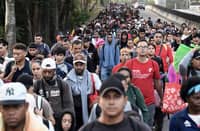 Migrants from a caravan in Tapachula, Chiapas state, Mexico, march while heading to the US border on 20 January 2025. US President Donald Trump was sworn in for a historic second term pledging a blitz of immediate orders on immigration aimed at re-shaping how the United States deals with citizenship and immigration, and the US culture wars as he caps his extraordinary comeback.