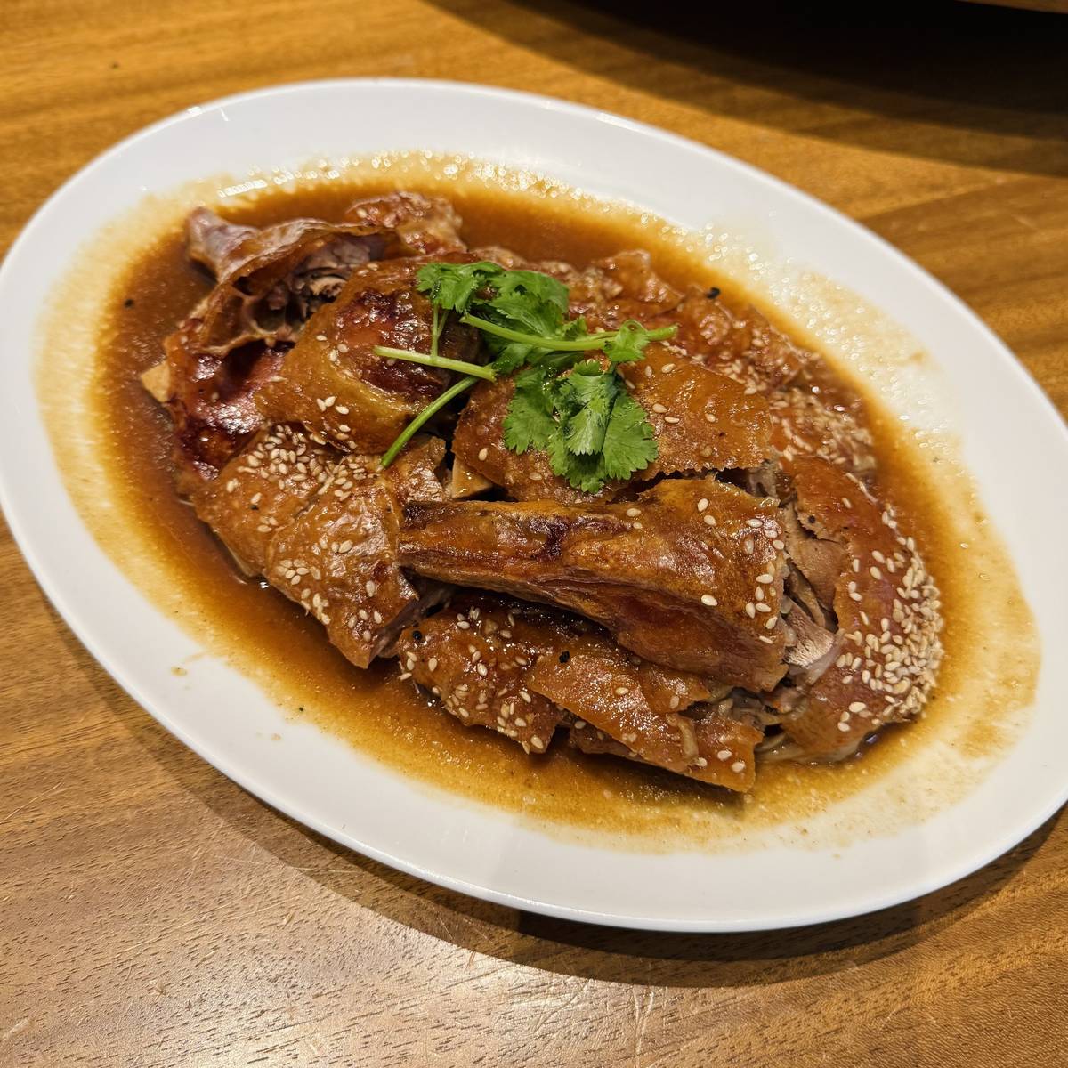 Roasted sesame duck with wild black pepper barbecue sauce.