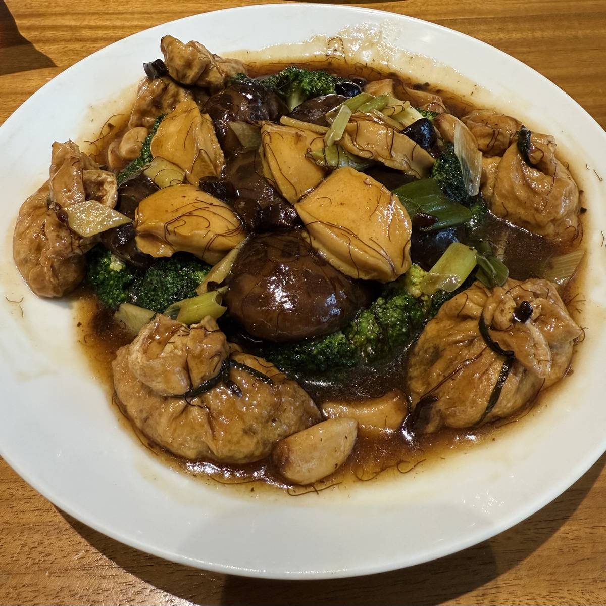 Braised 10 head abalone, dry oyster money bag and mushroom with black garlic. .sea moss sauce