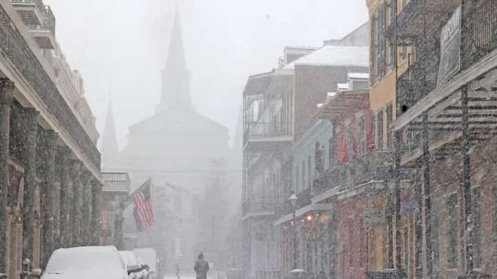 A cathedral in the French Quarter of New Orleans is barely visible in heavy snow that has blanketed the southern US city in a rare winter storm