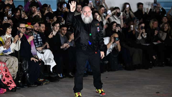 Belgian fashion designer Walter Van Beirendonck waves to attendees after his Menswear Ready-to-wear Fall-Winter 2025/2026 collection as part of the Paris Fashion Week, in Paris on 22 January 2025.