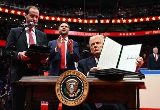 US President Donald Trump holds an executive order announcing the US withdrawal from the Paris Agreement, he just signed during the inaugural parade inside Capital One Arena, in Washington, DC, on 20 January 2025.