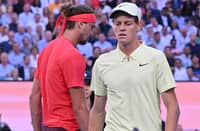 Italy's Jannik Sinner and Germany's Alexander Zverev walk between games during their men's singles final
