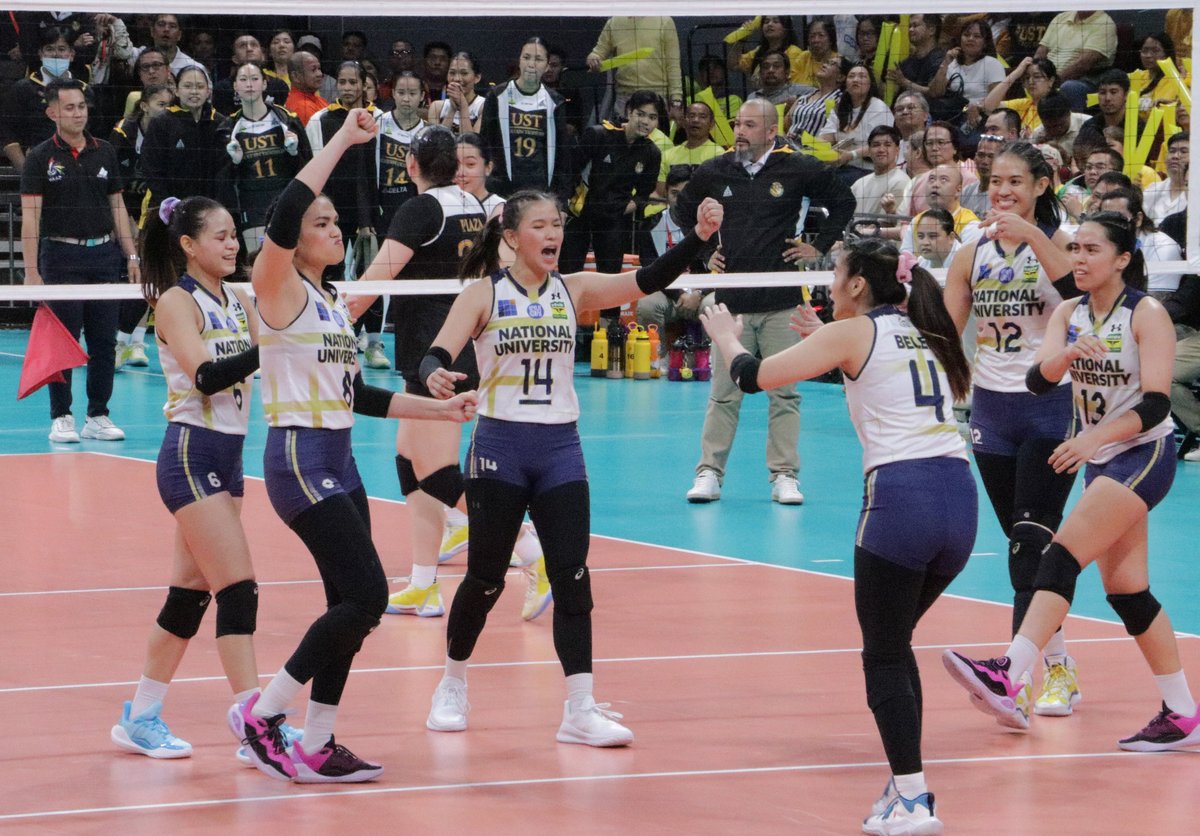 National University (NU) Lady Bulldogs volleyball players celebrate a point against the University of Santo Tomas (UST) Golden Tigresses