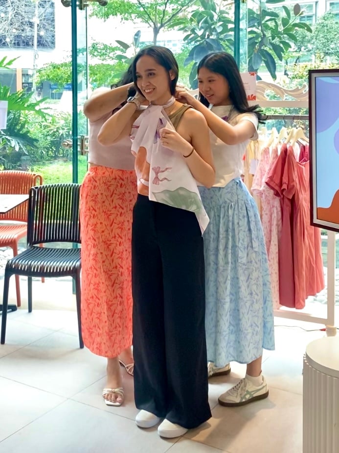 Andrea and Sadie demonstrate ways to style Loca's iconic scarf