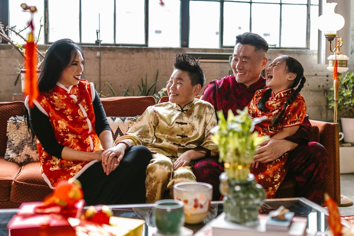 A family dressed in traditional attire, celebrating the warmth and togetherness of Lunar New Year.