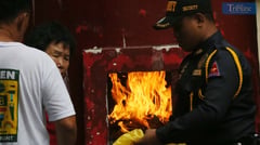Burning joss paper at Philippine Thai To Taoist Temple
