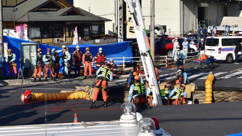 Japan trucker still stuck in sinkhole after 24 hours
