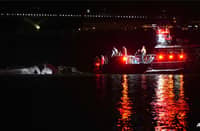 Emergency response units assess helicopter wreckage in the Potomac River near Ronald Reagan Washington Airport on Jan 30, 2025 in Arlington, Virginia.
