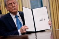 U.S. President Donald Trump hold up an executive order, "Unleashing prosperity through deregulation," that he signed in the Oval Office on 31 January 2025 in Washington, DC. Trump spoke to reporters about tariffs against China, Canada and Mexico and how the newly confirmed Interior Secretary Doug Burghum will coordinate with the Energy Department and the Environmental Protection Agency.