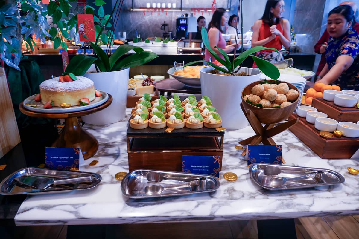 The dessert selection of Chinese Egg Sponge Cake, Hong Kong Egg Tarts, and Sesame Balls.