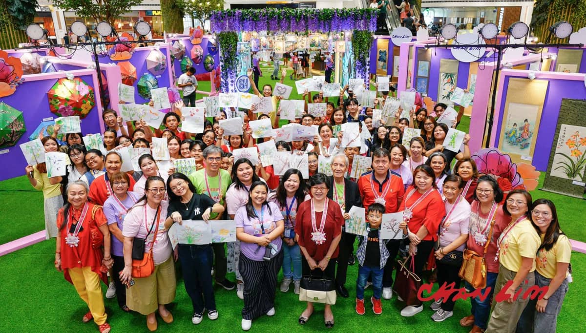 Excited to keep tradition alive, Dr. Alex Chan Lim and his family pose with students proudly showed off their paintings after the workshop.
