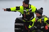 ALEXANDRIA, VIRGINIA - JANUARY 31: Members of the Alexandria Fire Department look for debris near the crash site of an American Airlines plane along the shoreline of the Potomac River on January 31, 2025 in Alexandria, Virginia. The American Airlines flight from Wichita, Kansas collided midair with a military Black Hawk helicopter while on approach to Ronald Reagan Washington National Airport. According to reports, there were no survivors among the 67 people on both aircraft.
