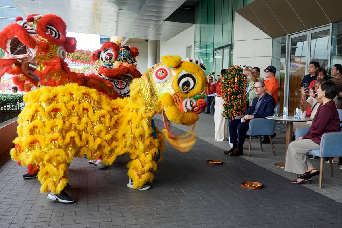 Three lions dance  in front of the Lanson Place executives and guests.