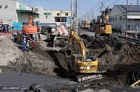 LOOK: Excavators and rescue personnel working to construct a slope for rescue operations are seen at the site where a truck on January 28 plunged into a sinkhole, trapping the vehicle's driver, in Yashio, Saitama Prefecture on February 1, 2025. Japanese rescuers completed building a slope on February 1 to reach a truck driver stuck in a sinkhole, officials said, four days after his vehicle was swallowed by the cavity now 40 meters wide.