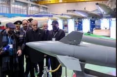 In this handout picture President Masoud Pezeshkian (C) visits a defence and space achievements exhibition in Tehran.