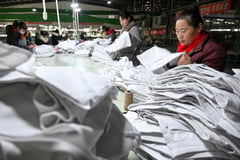 China shrugs off Trump tariffs but bruising trade war looms