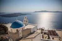 (FILES) This general view shows the Three Bells of Fira, the Catholic Church of the Dormition, in the village of Fira on the Greek island of Santorini on 19 July 2024. Schools on the Greek tourist island of Santorini will remain closed on February 3, 2025, after dozens of small earthquakes shook the region, civil protection authorities announced. Government officials, including Civil Protection Minister Vasilis Kikilias ordered the move on 2 February, after a series of tremors in the sea around Santorini and surrounding islands, the site of one of the largest volcanic eruptions in recorded history.