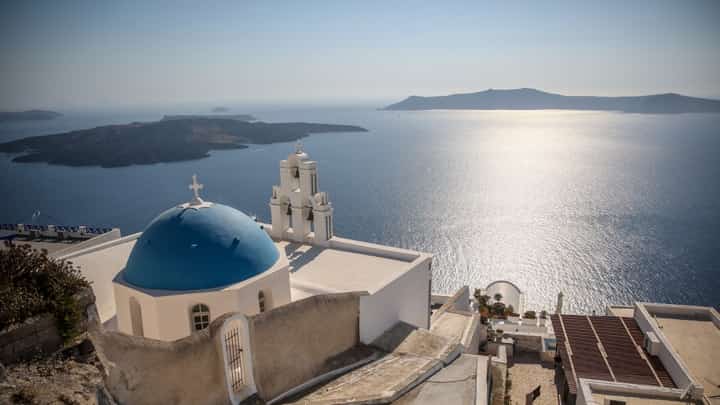 (FILES) This general view shows the Three Bells of Fira, the Catholic Church of the Dormition, in the village of Fira on the Greek island of Santorini on 19 July 2024. Schools on the Greek tourist island of Santorini will remain closed on February 3, 2025, after dozens of small earthquakes shook the region, civil protection authorities announced. Government officials, including Civil Protection Minister Vasilis Kikilias ordered the move on 2 February, after a series of tremors in the sea around Santorini and surrounding islands, the site of one of the largest volcanic eruptions in recorded history.