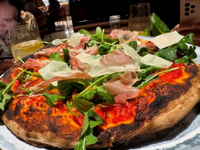 The signature Trattoria Pizza is a must-try, featuring a delightful combination of mortadella, burrata and ground pistachios.