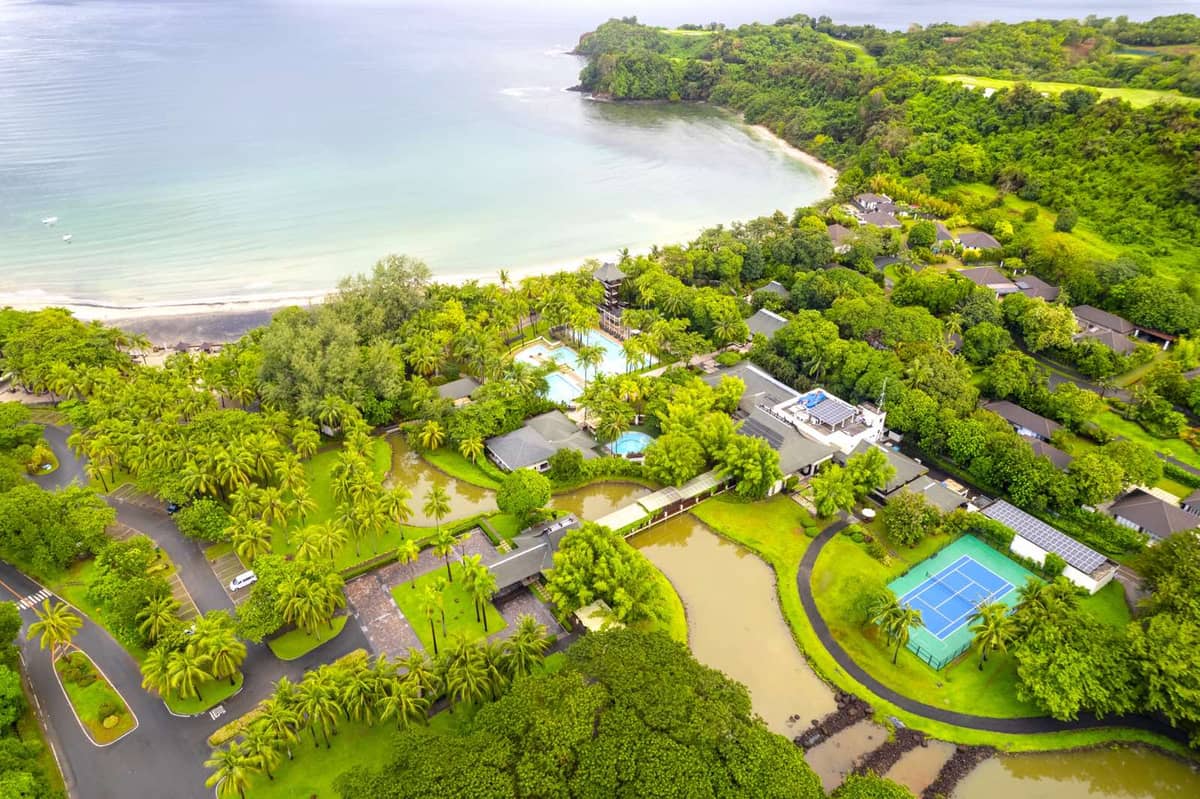 Anvaya Searidge Residences offers numerous amenities including a pool complex, tennis and basketball courts, and access to the beach.