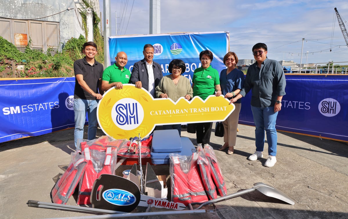 Department of Environment and Natural Resources (DENR) Secretary Maria Antonia Yulo-Loyzaga (middle) receives the symbolic key to a catamaran donated by SM Prime, boosting Manila Bay cleanup efforts.
