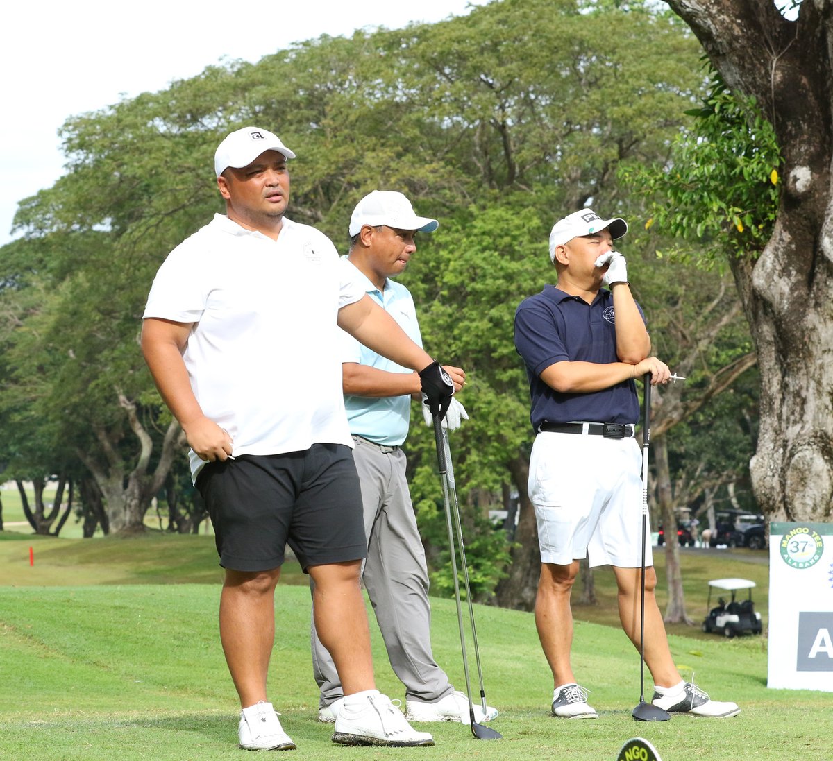 Dax Ramon Garcia, Raymund Sangil and Victor Vergel De Dios wait for their turn on the 11th hole.