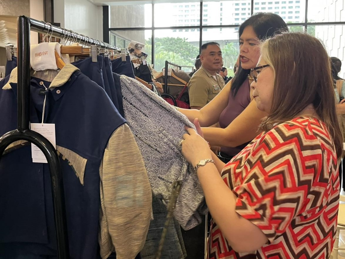 Guests browse through the collection of handcrafted clothes at the event.