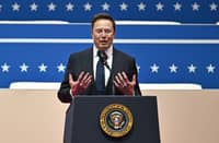 Tesla and SpaceX CEO Elon Musk gestures as he speaks during the inaugural parade inside Capital One Arena in Washington, DC.